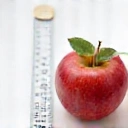 Icona di correzione del peso, con una mela e un nastro di misurazione